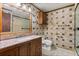 Bathroom with tiled walls, granite countertop vanity, and glass-enclosed shower at 6157 Ne 25Th Ave, Ocala, FL 34479