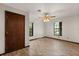 Bedroom with wood-look floors, ceiling fan, and two large windows at 6157 Ne 25Th Ave, Ocala, FL 34479