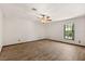 Bedroom with wood-look floors, ceiling fan, and natural light from a window at 6157 Ne 25Th Ave, Ocala, FL 34479