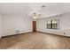 Minimalist bedroom with a ceiling fan, window, and wood-look flooring at 6157 Ne 25Th Ave, Ocala, FL 34479
