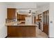 A kitchen features wood cabinets, a breakfast bar, and stone countertops and backsplash at 6157 Ne 25Th Ave, Ocala, FL 34479