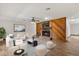 Cozy living room with a brick fireplace, wood paneling, and comfortable seating at 6157 Ne 25Th Ave, Ocala, FL 34479
