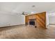 Bright living room with a brick fireplace, wood accents, and wood-look flooring at 6157 Ne 25Th Ave, Ocala, FL 34479