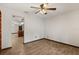 A well-lit living room offers wood-look tile flooring, neutral walls and ceiling fan at 6157 Ne 25Th Ave, Ocala, FL 34479