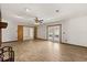 Spacious living room with wood-look flooring and French doors leading to the back patio at 6157 Ne 25Th Ave, Ocala, FL 34479