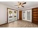 The living room features wood-look tile flooring, ceiling fan, and views into the screened patio at 6157 Ne 25Th Ave, Ocala, FL 34479