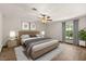 This main bedroom features modern lighting, a large bed, side tables and a window with coverings at 6157 Ne 25Th Ave, Ocala, FL 34479