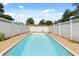 Backyard pool with a tiled pool deck and privacy fence at 6157 Ne 25Th Ave, Ocala, FL 34479