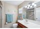 Clean bathroom with vanity, shower, toilet and decorative mirror with lighting at 6448 Sw 111Th Pl, Ocala, FL 34476