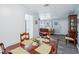 Bright dining room with laminate floors, open access to the living room, and natural light at 6448 Sw 111Th Pl, Ocala, FL 34476
