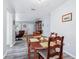 Cozy dining room featuring laminate flooring, a modern light fixture, and access to the living room at 6448 Sw 111Th Pl, Ocala, FL 34476