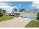 Well-maintained single-story home featuring a charming facade, two car garage, and a neatly landscaped front yard at 6448 Sw 111Th Pl, Ocala, FL 34476