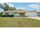 Charming single-story home featuring a well-maintained lawn, classic design, and attached two car garage at 6448 Sw 111Th Pl, Ocala, FL 34476