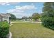 Spacious front yard with lush lawn, mature trees, and serene neighborhood setting at 6448 Sw 111Th Pl, Ocala, FL 34476