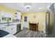 Bright eat-in kitchen featuring white cabinets, stainless appliances, and stylish tiled backsplash at 6448 Sw 111Th Pl, Ocala, FL 34476