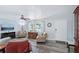 Inviting living room features laminate floors, a ceiling fan, and a large front door at 6448 Sw 111Th Pl, Ocala, FL 34476