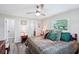 Relaxing main bedroom with ceiling fan, wood-look flooring, and ensuite bathroom at 6448 Sw 111Th Pl, Ocala, FL 34476