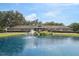 Picturesque community with a tranquil pond featuring a fountain and beautifully landscaped surroundings at 6448 Sw 111Th Pl, Ocala, FL 34476