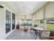 Bright sunroom with tile flooring, ceiling fan, neutral walls, and large windows overlooking the outdoors at 6448 Sw 111Th Pl, Ocala, FL 34476