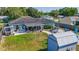 Aerial view of landscaped backyard with pool, shed, patio, and outdoor seating at 7 Larch Dr, Ocala, FL 34480