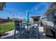 Backyard featuring patio seating area with grill, umbrella, and green lawn at 7 Larch Dr, Ocala, FL 34480