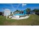 A spacious backyard features an above-ground pool, a storage shed, and lush greenery at 7 Larch Dr, Ocala, FL 34480