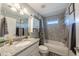 Bathroom featuring gray tiling, a shower-tub combination, and white cabinets, offering a clean and modern space at 7 Larch Dr, Ocala, FL 34480