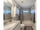 Bathroom featuring gray tiling, a shower-tub combination, and white cabinets, offering a clean and modern space at 7 Larch Dr, Ocala, FL 34480