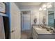 Bathroom featuring gray tiling, a shower-tub combination, white cabinets, offering a functional space at 7 Larch Dr, Ocala, FL 34480