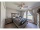 A serene bedroom features gray walls, a ceiling fan, plush carpet, and natural light creating a restful retreat at 7 Larch Dr, Ocala, FL 34480
