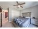 A serene bedroom features gray walls, a ceiling fan, plush carpet, and natural light creating a restful retreat at 7 Larch Dr, Ocala, FL 34480
