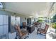 Spacious covered patio featuring outdoor seating, fridge, grill, and ceiling fan at 7 Larch Dr, Ocala, FL 34480
