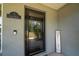 Close-up of a front door with a welcome sign and house number, showing detailed trim and a secure entryway at 7 Larch Dr, Ocala, FL 34480
