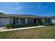 Beautiful one-story home with dark shutters, an attached garage, manicured landscaping, and a well-maintained lawn at 7 Larch Dr, Ocala, FL 34480
