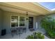 Charming front porch features a seating area, welcome mat, and decorative plants by the front door at 7 Larch Dr, Ocala, FL 34480