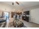 Open-concept living room and kitchen featuring hardwood floors, ceiling fan and an island with barstool seating at 7 Larch Dr, Ocala, FL 34480