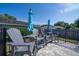 View of gray Adirondack chairs with tables surrounding fenced-in pool at 7 Larch Dr, Ocala, FL 34480