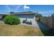 A side yard features a gravel path, a wooden fence, and access to the backyard and outdoor utilities at 7 Larch Dr, Ocala, FL 34480