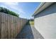 Property features side yard access with a gravel path and wooden fence, providing practicality at 7 Larch Dr, Ocala, FL 34480