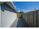Convenient side yard access with a gravel path and wooden fence offers practicality and privacy at 7 Larch Dr, Ocala, FL 34480
