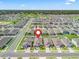 Expansive aerial view of a residential neighborhood with well-maintained lawns and a golf course in the distance at 7206 Sw 60Th Ln, Ocala, FL 34474