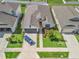 Bird's eye view of a lovely home with beautiful landscaping, a gray garage door, and a long driveway at 7206 Sw 60Th Ln, Ocala, FL 34474