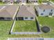 Aerial view of a home with a spacious, fenced backyard and patio, showcasing the property's layout and outdoor amenities at 7206 Sw 60Th Ln, Ocala, FL 34474