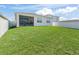Expansive backyard with well-maintained lawn and privacy fence, offering ample space for outdoor activities and landscaping at 7206 Sw 60Th Ln, Ocala, FL 34474