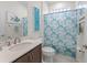 Well-lit bathroom featuring a stylish vanity and a patterned shower curtain at 7206 Sw 60Th Ln, Ocala, FL 34474