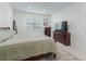 This bedroom features a plush bed, dresser, side tables, and a window providing natural light at 7206 Sw 60Th Ln, Ocala, FL 34474