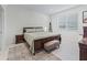 The bedroom features neutral decor, wood furniture, and a large window providing natural light at 7206 Sw 60Th Ln, Ocala, FL 34474