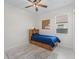 Cozy bedroom with natural light, a wooden bed frame, and tile flooring at 7206 Sw 60Th Ln, Ocala, FL 34474