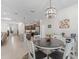 Bright dining area with a modern light fixture adjacent to the kitchen at 7206 Sw 60Th Ln, Ocala, FL 34474