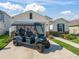 Inviting home featuring a golf cart and a well-manicured lawn at 7206 Sw 60Th Ln, Ocala, FL 34474